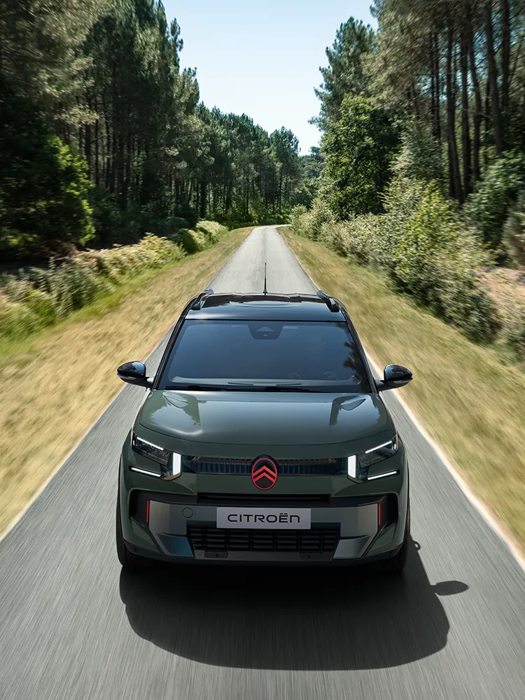 Top front view Citroën C3 Outdoor with LED signature shows Advanced Comfort compact SUV on forest road
