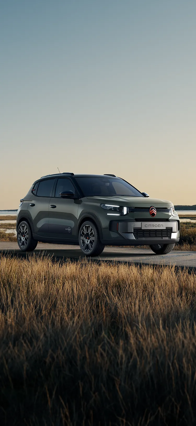 Front three-quarter view Citroën C3 Outdoor with LED signature shows Advanced Comfort SUV beside coastal wetlands
