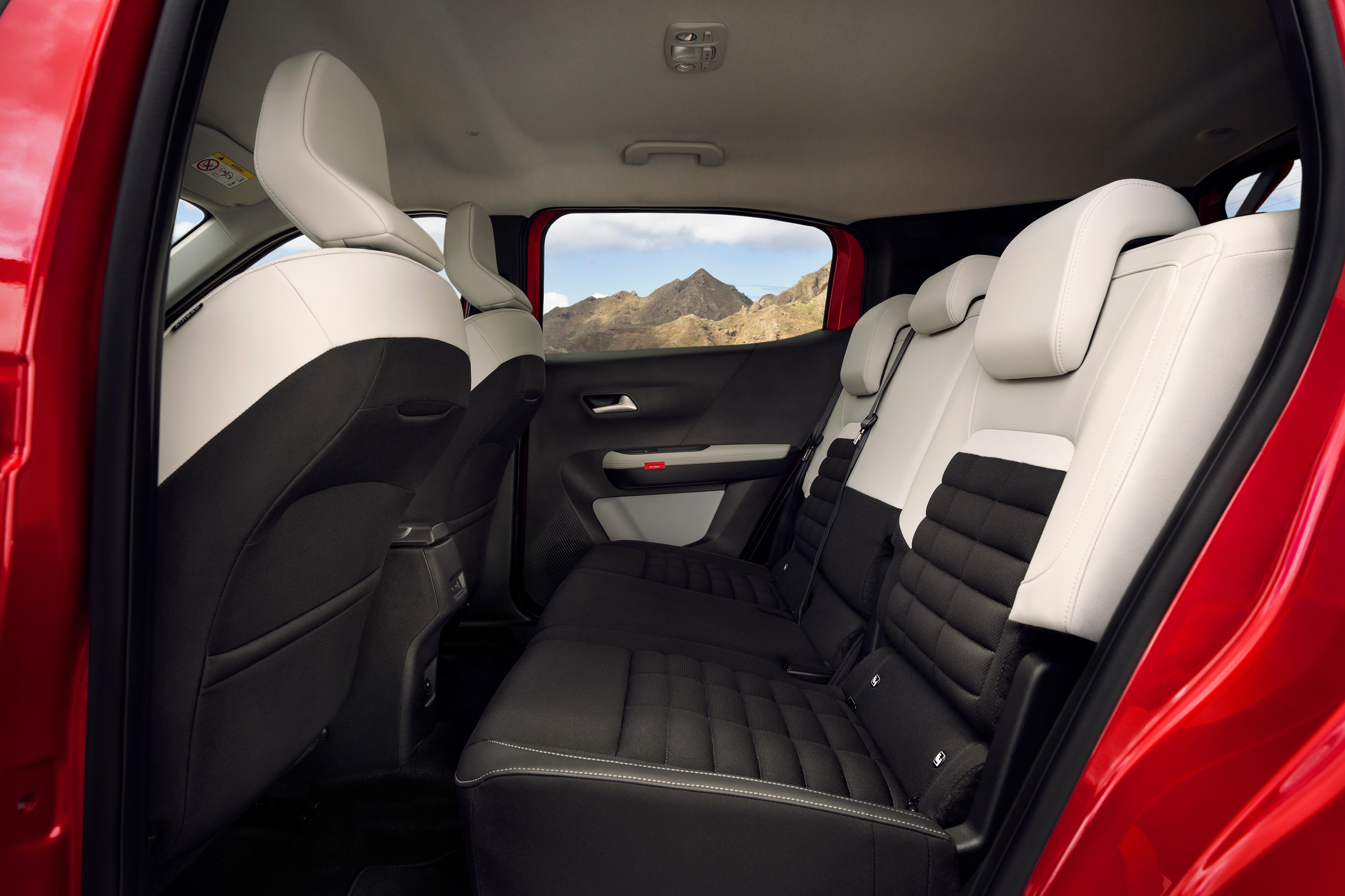 Rear passenger seats of the Citroën compact SUV shown with black and white upholstery and mountain view outside
