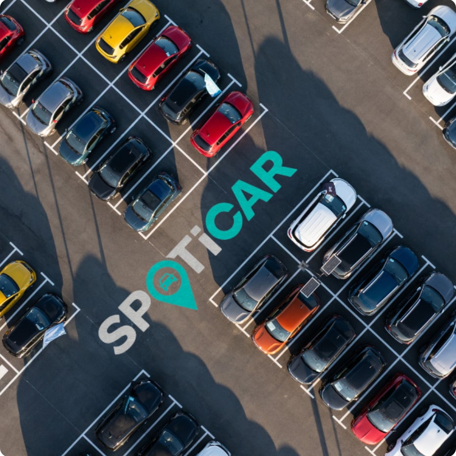 Aerial view of a Spoticar parking area showcasing inspected used vehicles available with transparent, reliable customer guarantees.