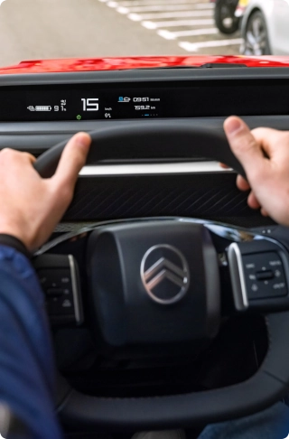 Interior view of the Citroën ë-C3 Van cockpit, highlighting the multifunction steering wheel and driver-focused controls.Afficher plus de lignes