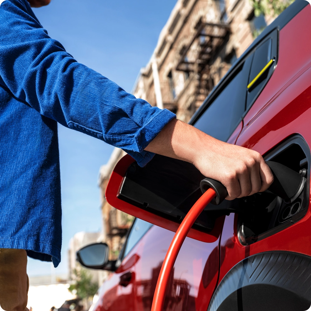 Close-up view of the Citroën ë-C3 Van charging port connected to a charging cable, highlighting convenient electric charging and zero-emission mobility.