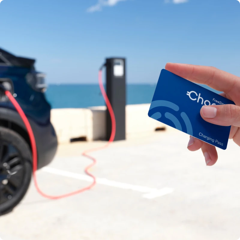 Close-up view of a charging access card near a public charging station, highlighting easy access to charging networks for the Citroën ë-C3 Van.