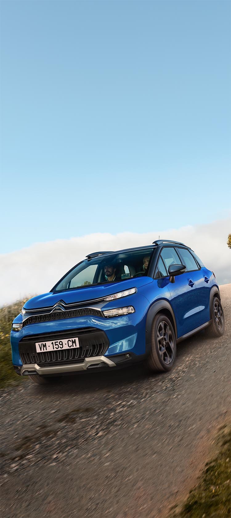 C3 Aircross SUV driving on sloping country road