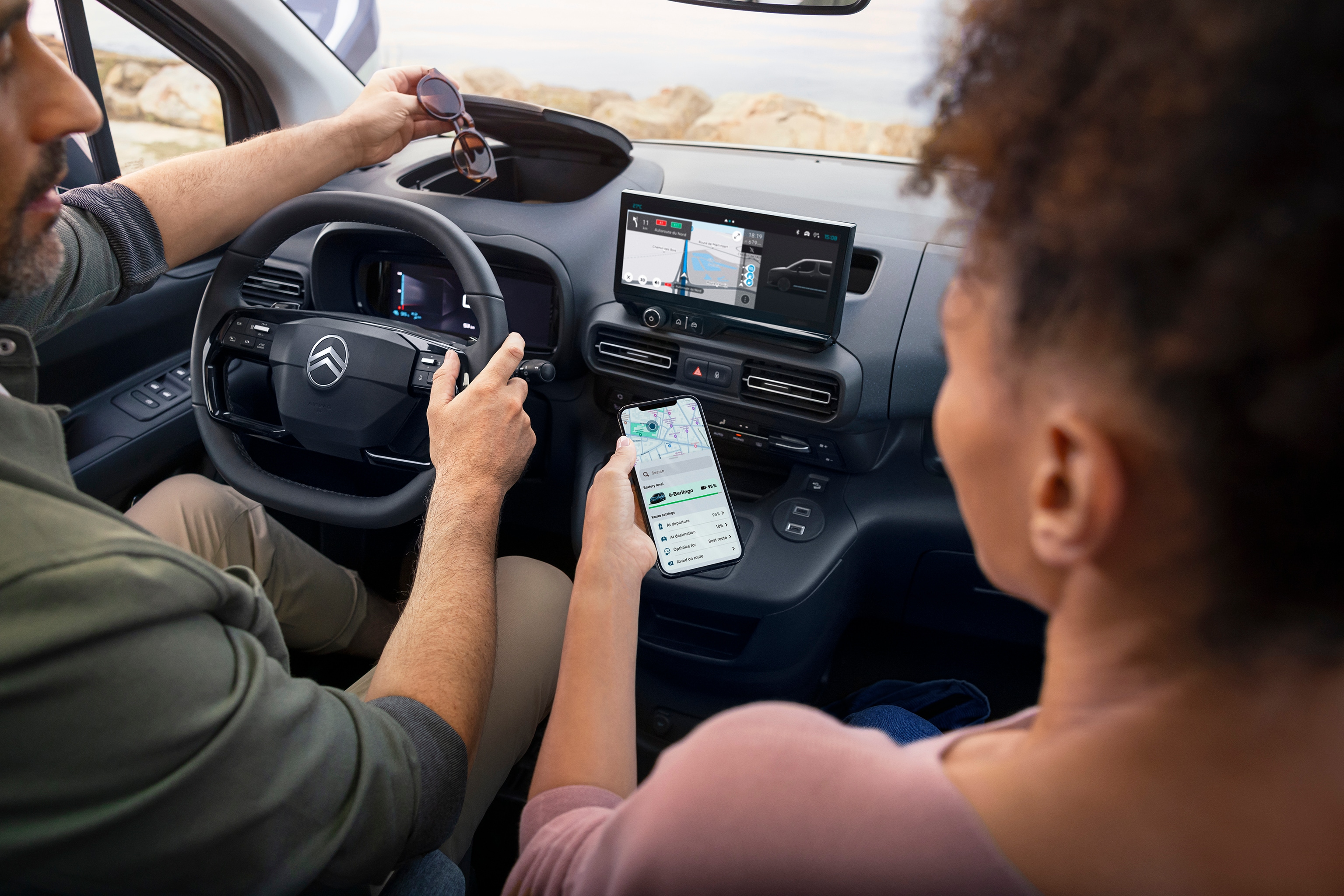 Woman looking at her MyCitroën app inside ë-Berlingo